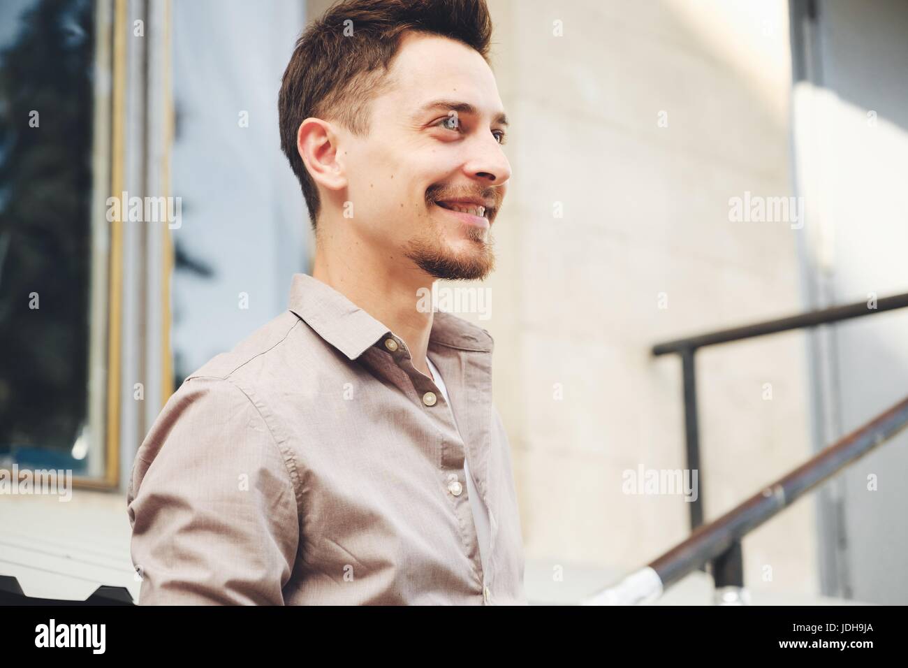 Handsome man outdoors portrait in the city. Warm colors Stock Photo - Alamy