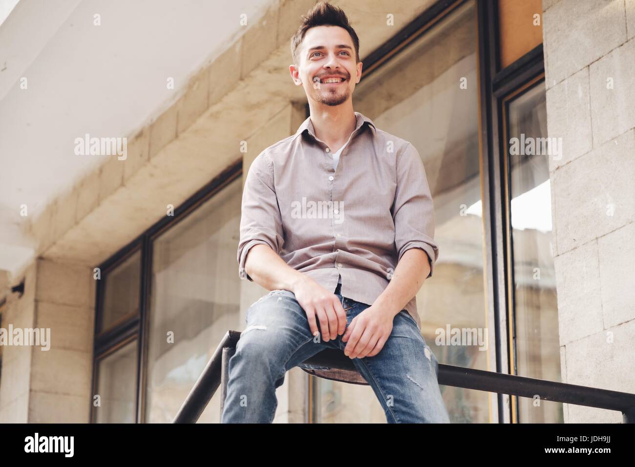 Handsome man outdoors portrait in the city. Warm colors Stock Photo - Alamy