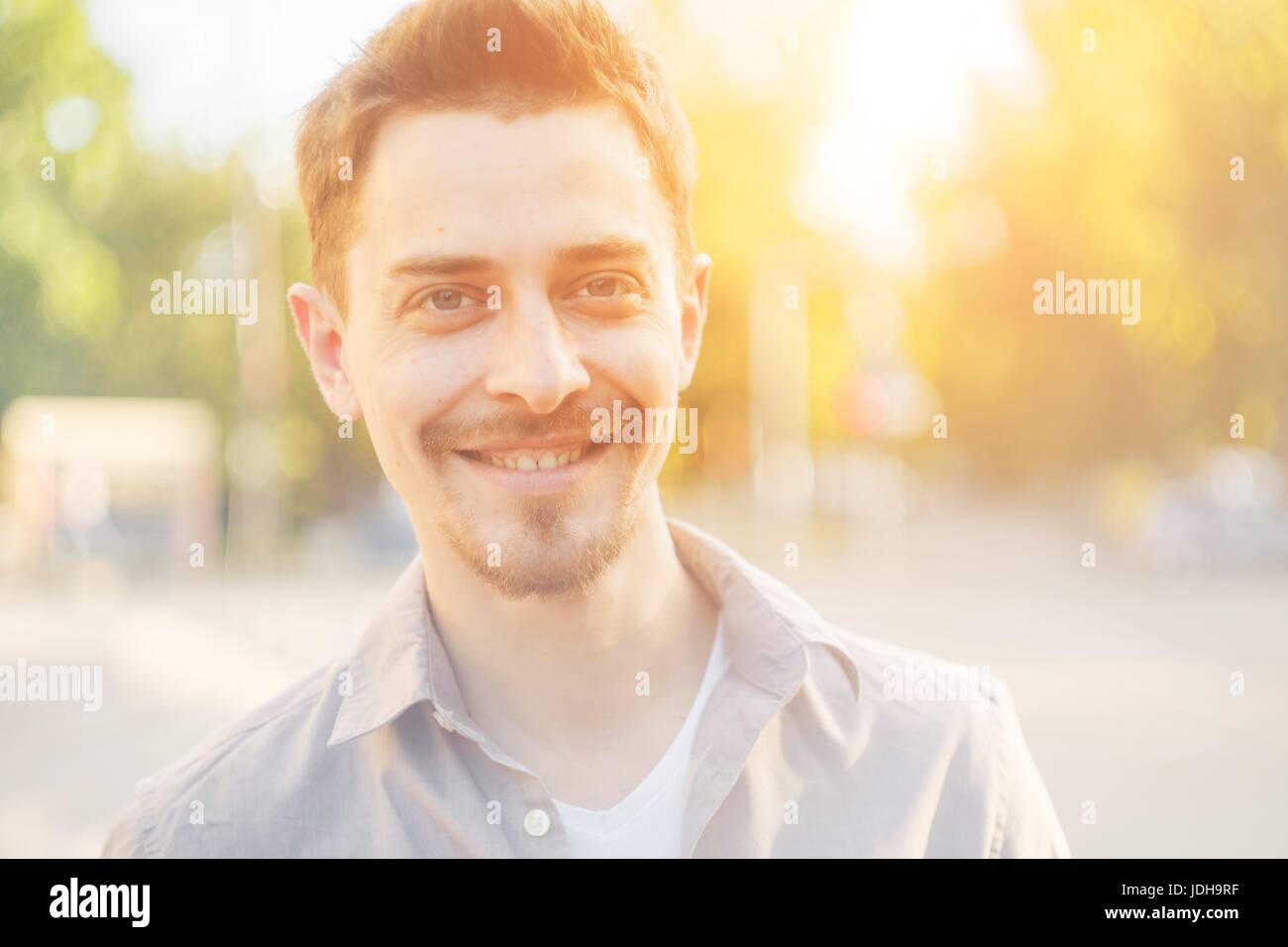 Handsome man outdoors portrait in the city. Warm colors Stock Photo - Alamy