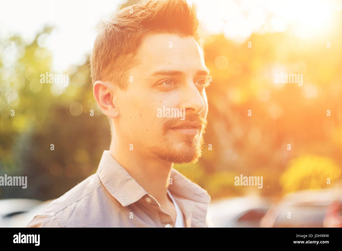 Handsome man outdoors portrait in the city. Warm colors Stock Photo - Alamy