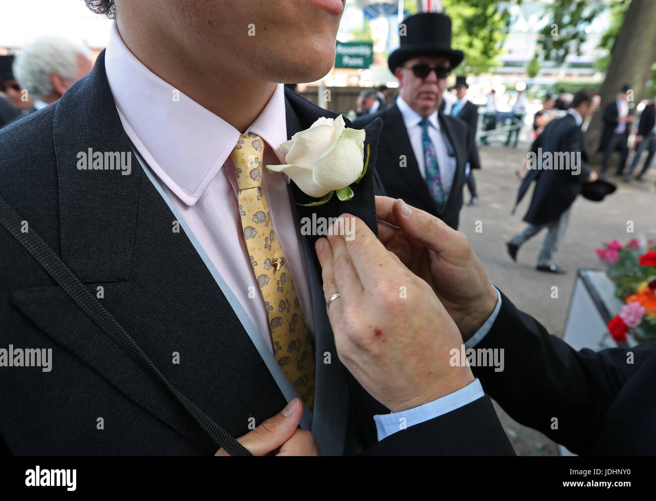 A gentleman is presented with a corsage during day one of Royal Ascot at Ascot Racecourse. Stock Photo