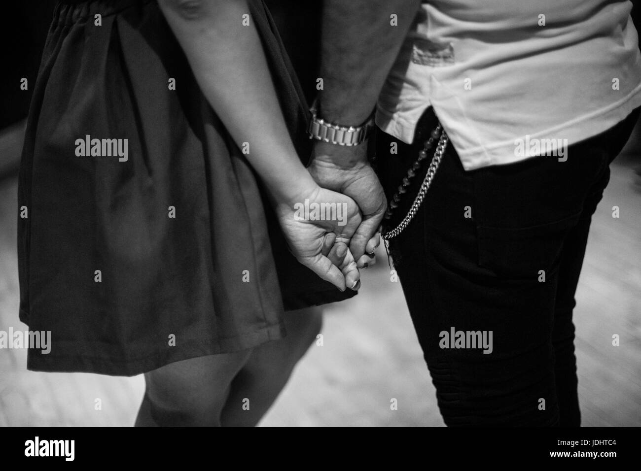White and black couple holding hands Black and White Stock Photos