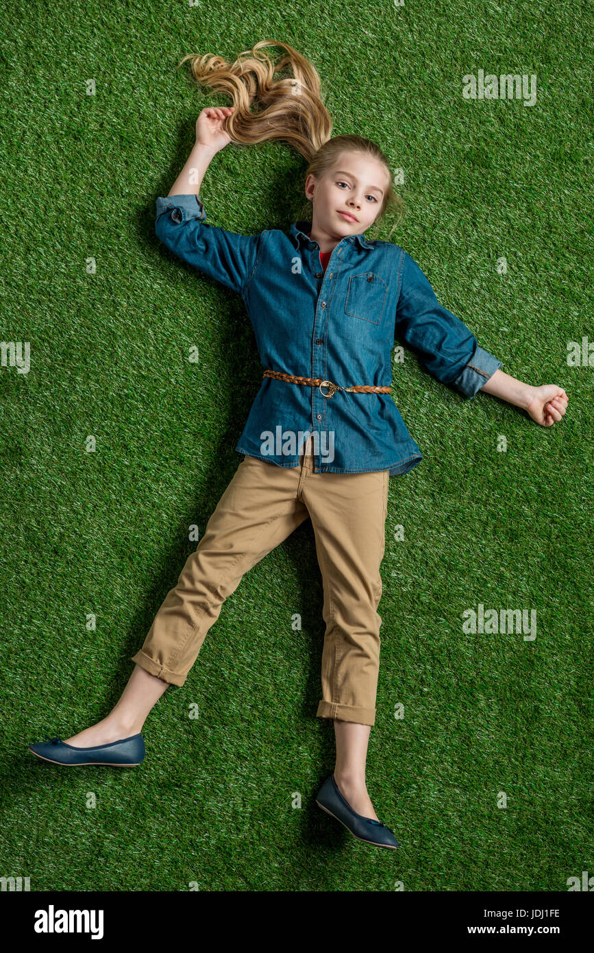 Preteen girl lying on grass hi-res stock photography and images - Alamy