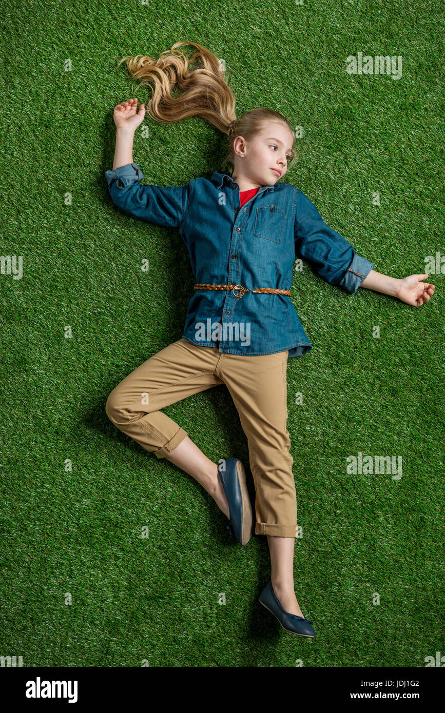 Preteen girl lying on grass hi-res stock photography and images - Alamy