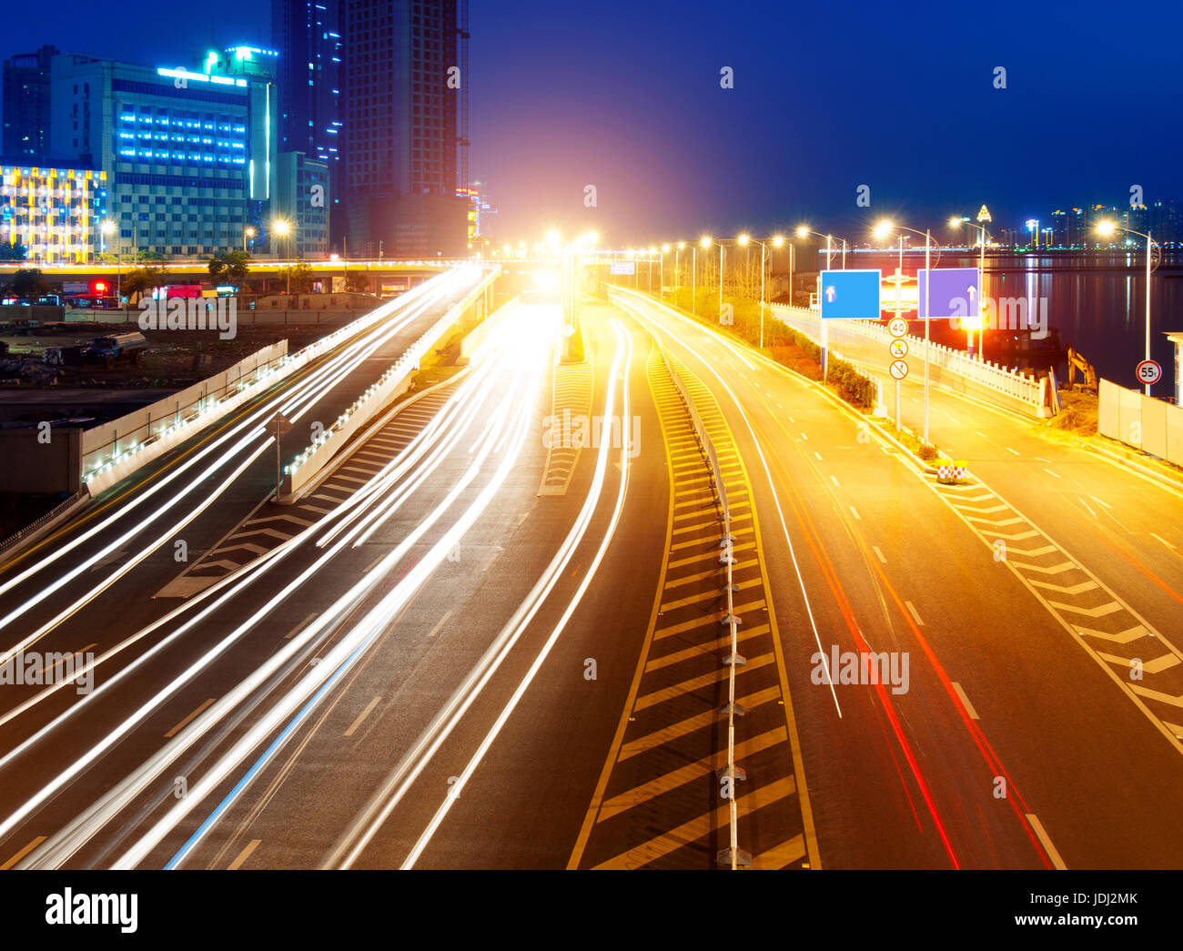 Highway light trails, modern city at night Stock Photo Alamy