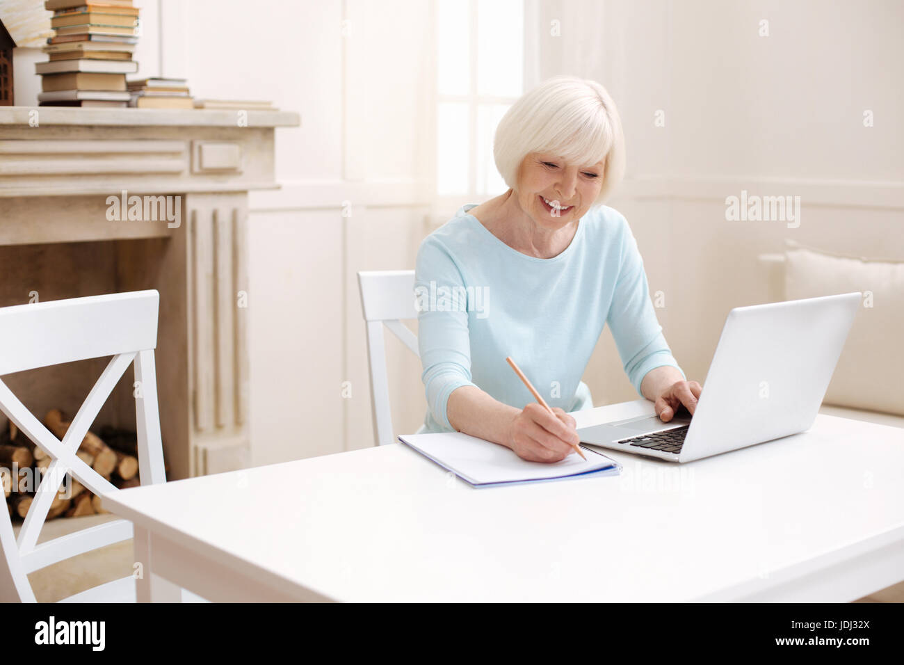 Lively bright lady writing down some tips Stock Photo
