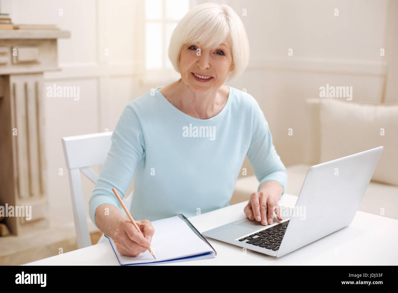 Lively aged woman busy as a bee Stock Photo