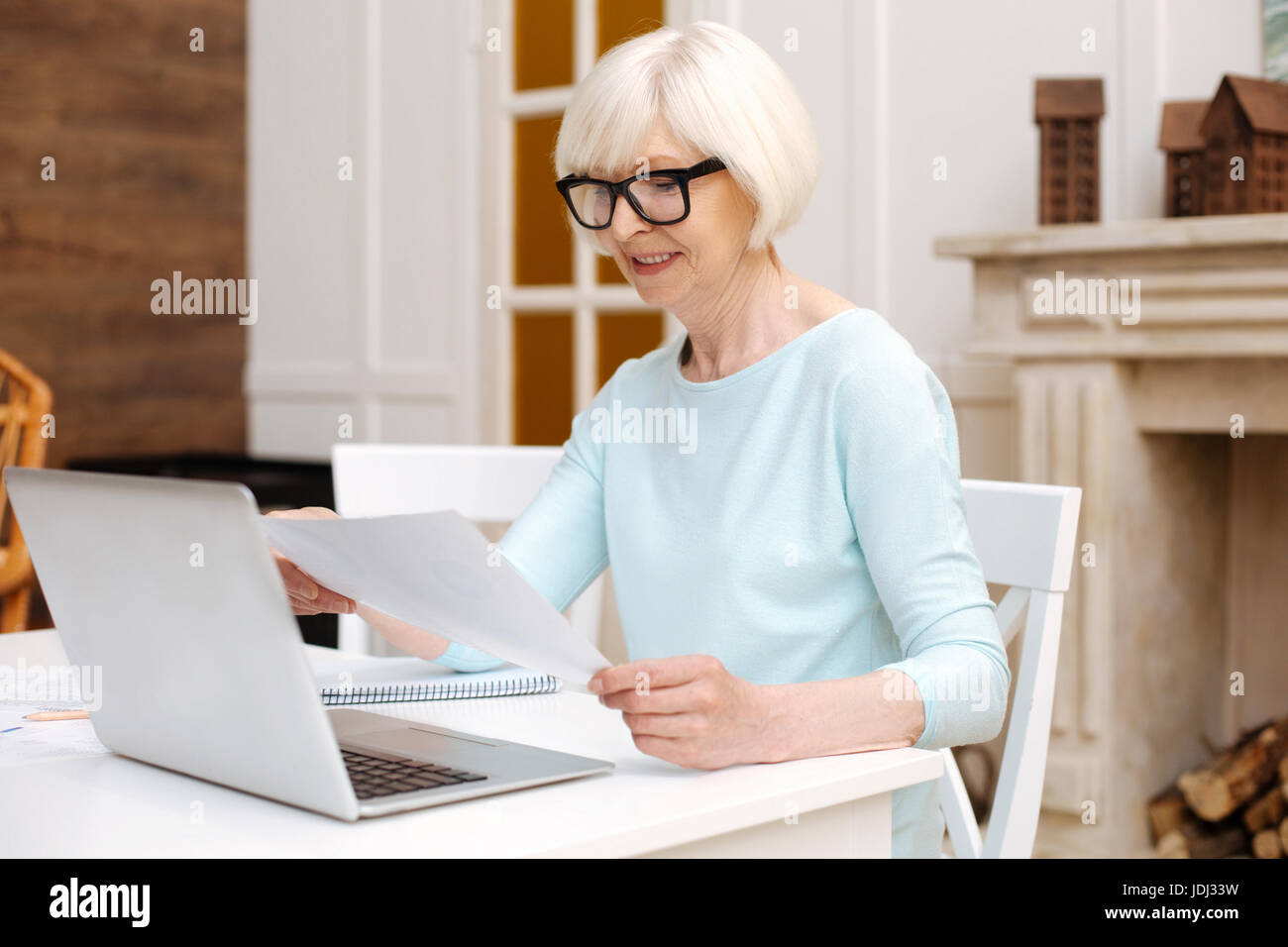 Committed professional lady perusing a report Stock Photo