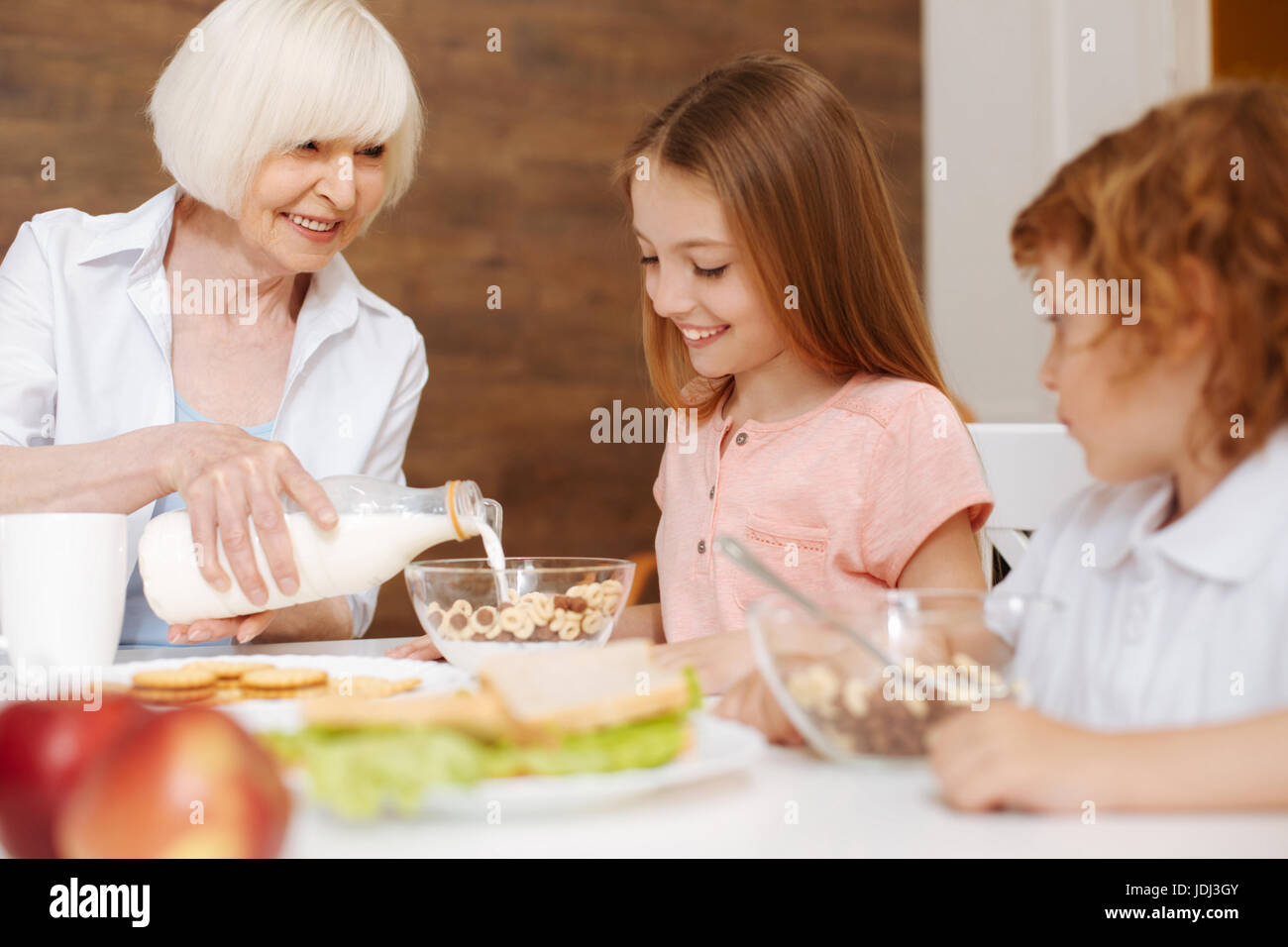 Loving grandma making breakfast for her grandchildren Stock Photo Alamy