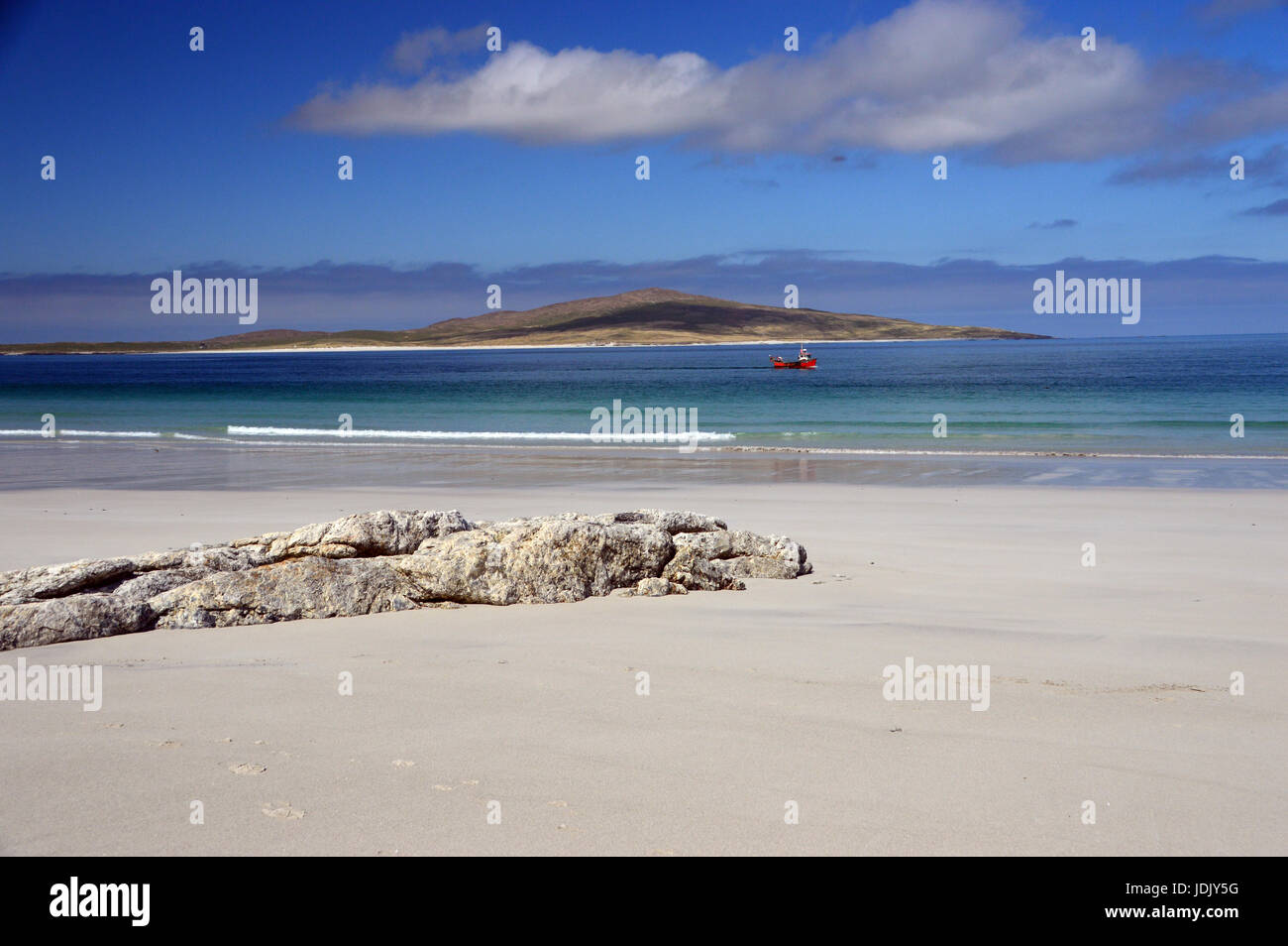 A Small Red Fishing Boat Passing West Beach on the Island of Berneray on North Uist with the Island of Pabbay in the Background, Outer Hebrides, Stock Photo