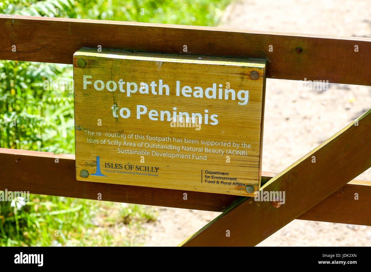 A sign on a wooden gate saying footpath to Peninnis Head, St. Mary's, Isles of Scilly, Cornwall, England, UK Stock Photo