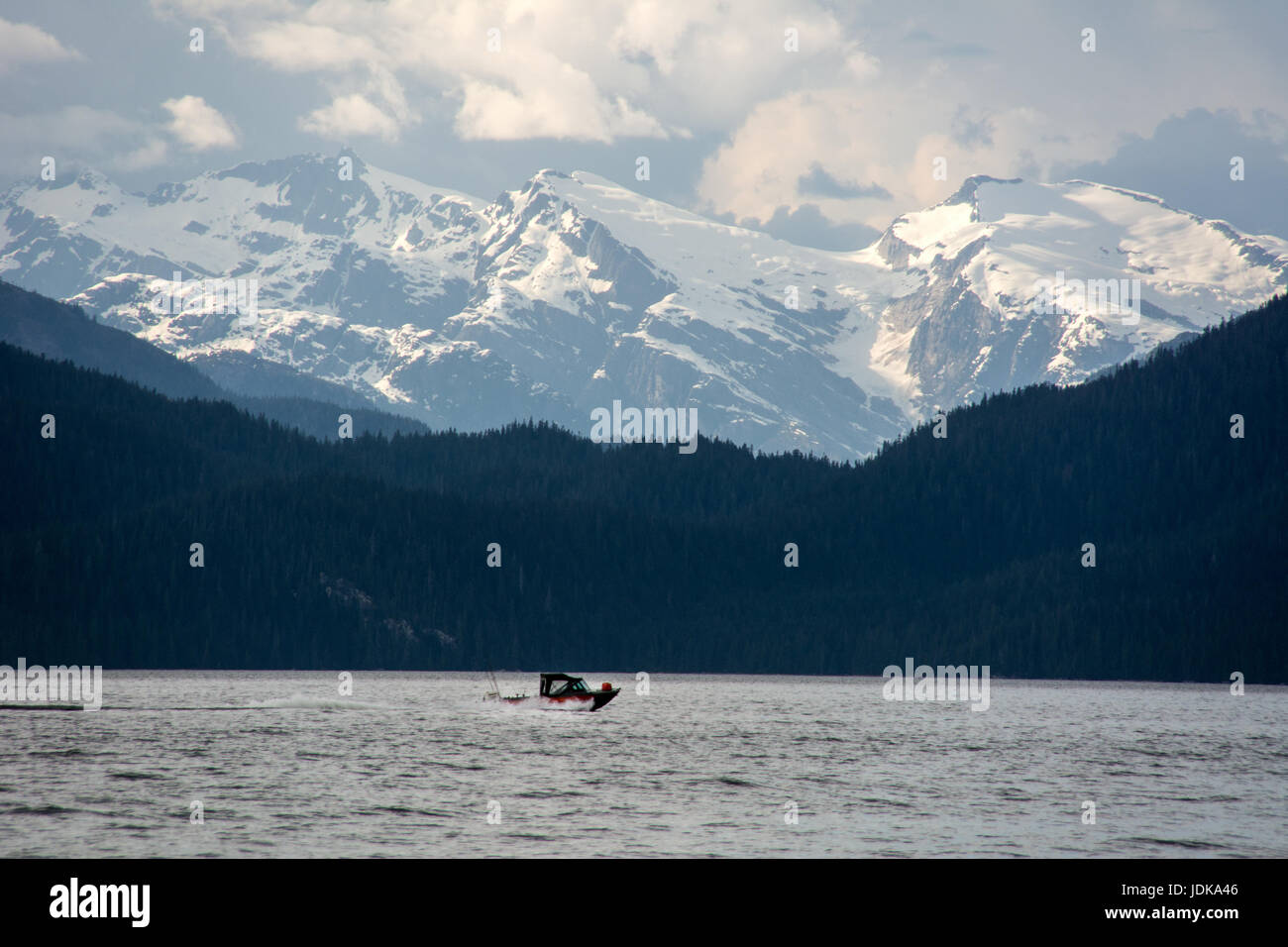 A motorboat travels through the Douglas Channel in the Great Bear Rainforest region, near Kitimat, on the north coast of British Columbia, Canada. Stock Photo