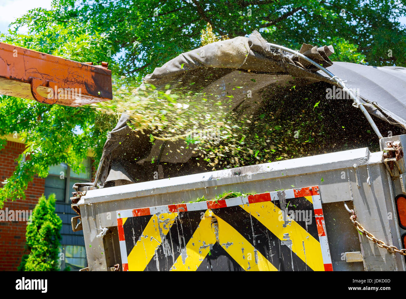 industrial wood chipper loading a truck with mulch Stock Photo