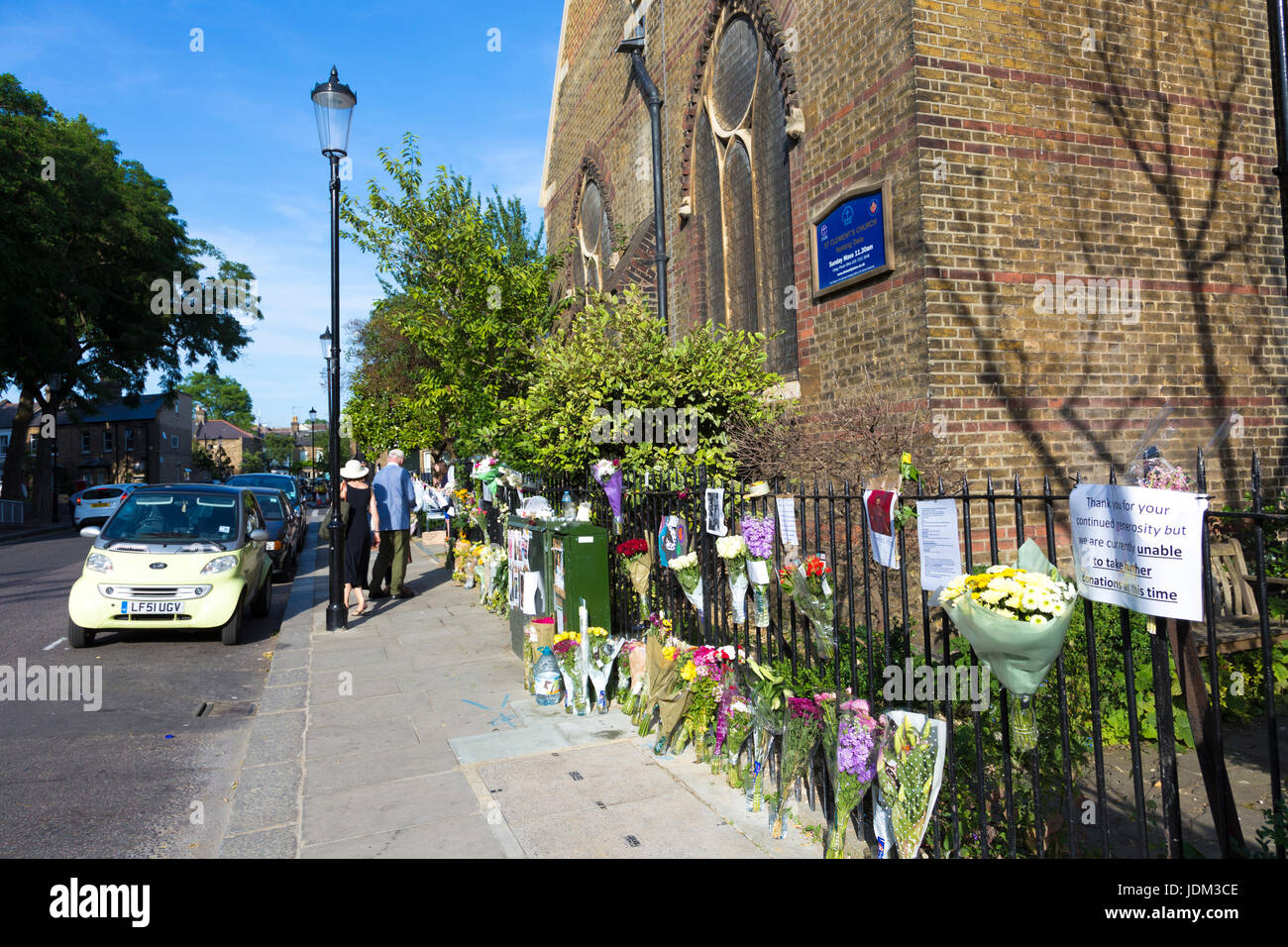 London, UK. 20th June 2017 - On 14 June 2017 Grenfell Tower, a 24-storey high tower block of public housing flats in North Kensington, west London, England was severely damaged by fire, causing a high number of casualties. People have come to lay flowers and pay tributes to the victims who lost their lives in the fire. Stock Photo