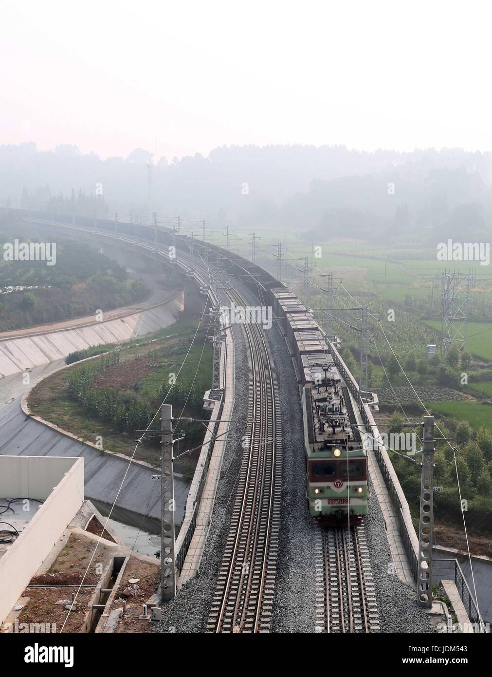 (170621) -- CHENGDU, June 21, 2017 (Xinhua) -- A train is seen in the Hualongmen to Pengshan section of the southwest China's Chengdu-Kunming Railway, June 21, 2017. The Hualongmen to Pengshan section of the double-track Chengdu-Kunming Railway opened Wednesday, a major breakthrough on the construction of the railway. (Xinhua/Kong Xiangwen)(wjq) Stock Photo