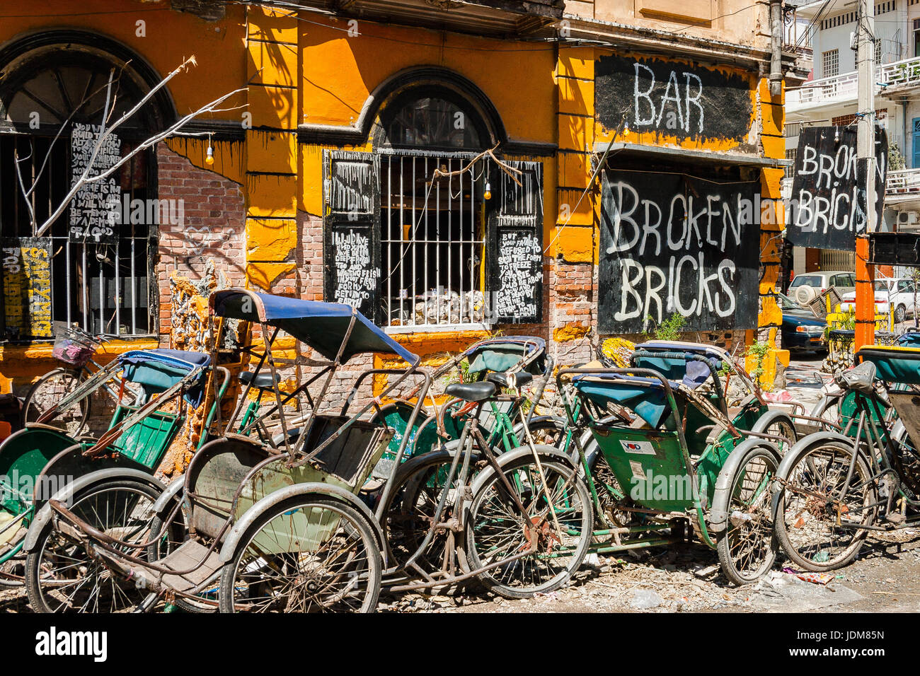Broken Bricks Bar, trishaws and graffiti art. Phnom Penh, Cambodia. Stock Photo
