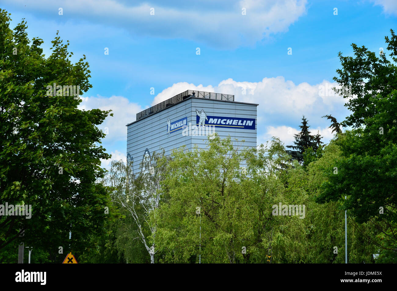 Michelin logo sign on blue sky background. Bibendum, commonly referred to as the Michelin Man, is the symbol of the Michelin tyre company.Michelin man Stock Photo