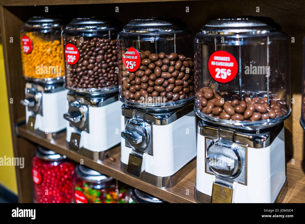 Chocolate covered almonds in French coin dispenser candy machines Stock  Photo - Alamy