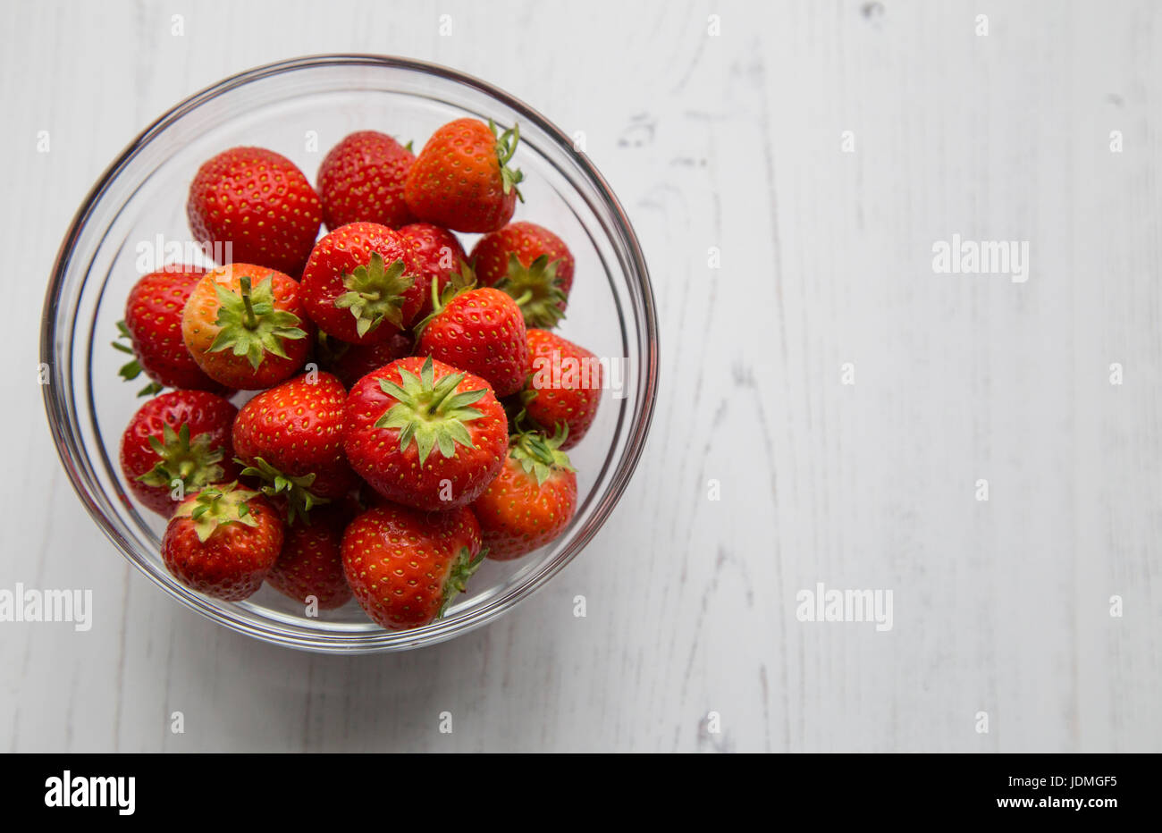 A bowl of fresh strawberries on a white background.seed Stock Photo - Alamy