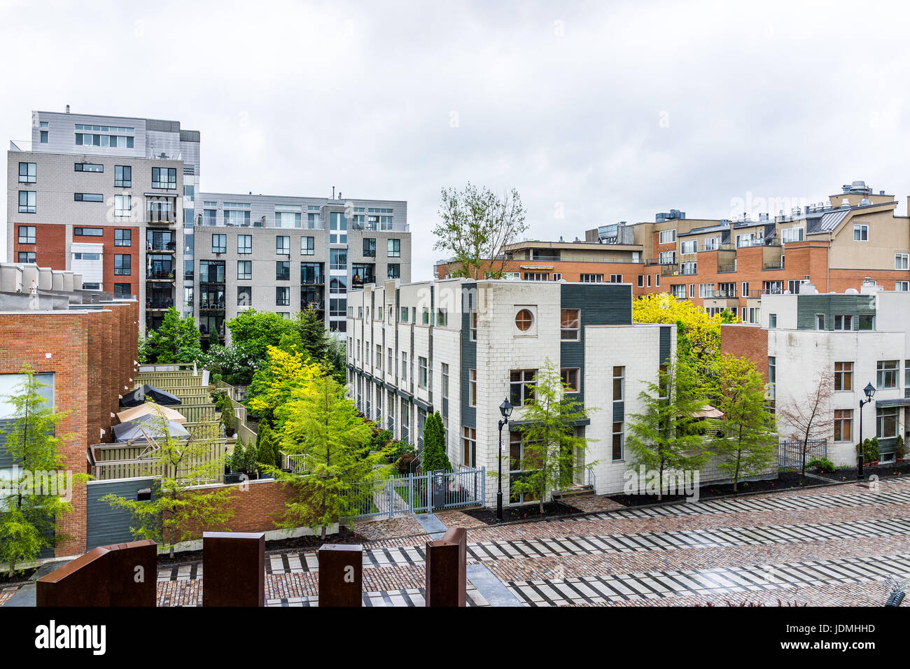 Montreal, Canada - May 26, 2017: Modern new apartment condos in city in Quebec region during rainy cloudy wet day Stock Photo