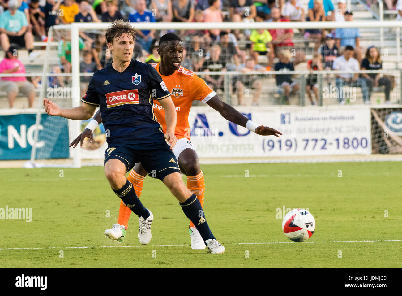 North Carolina FC forward Billy Schuler (17) and Houston Dynamo defender Jalil Anibaba (2) during a 2017 Lamar Hunt U.S. Open Cup match in Cary, NC. Stock Photo