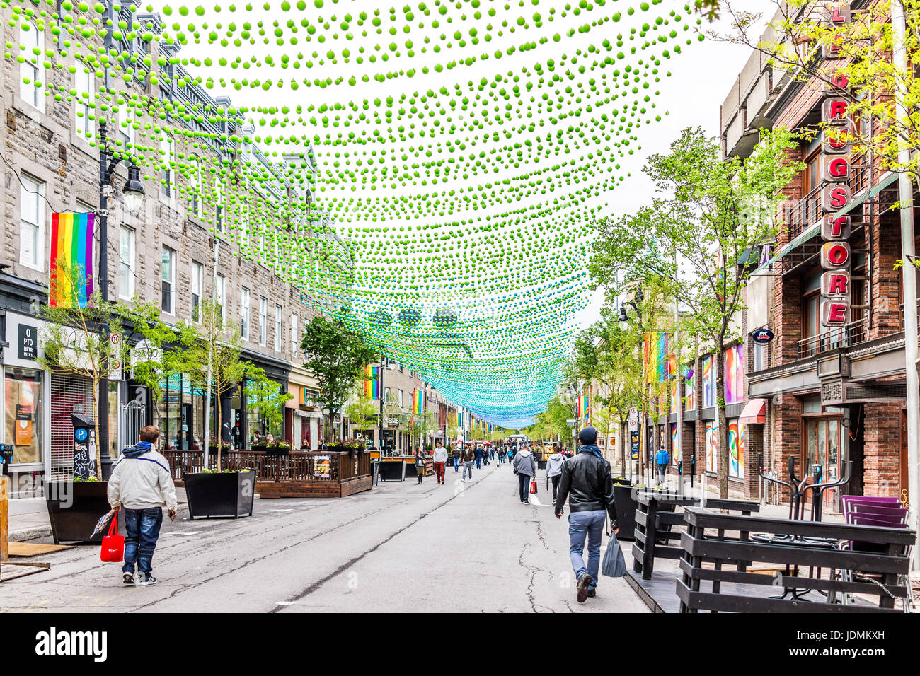 Montreal, Canada - May 26, 2017: People walking on Sainte Catherine street in Montreal's Gay Village in Quebec region with hanging decorations Stock Photo