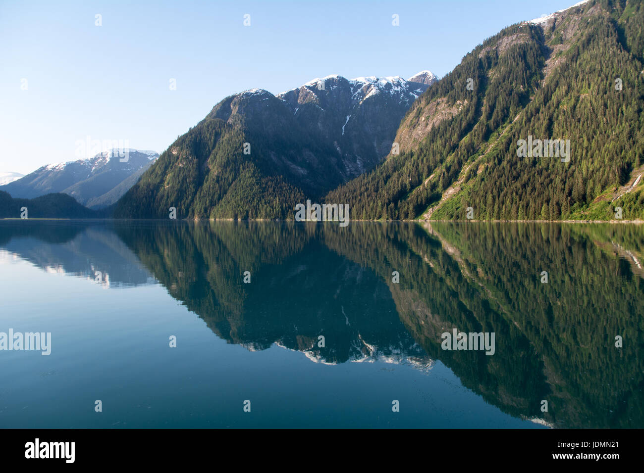 Mountain fjords reflected in the still coastal waters of the Kitlope region of the Great Bear Rainforest, British Columbia, Canada. Stock Photo