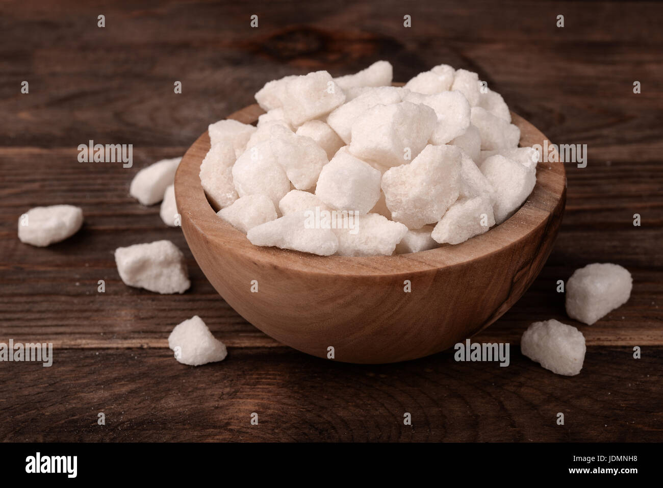 Bowl of natural lump sugar on wooden background Stock Photo