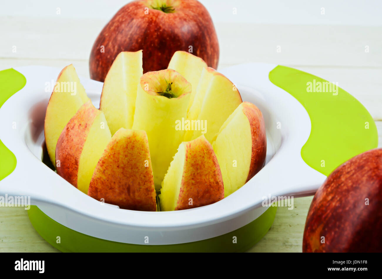 https://c8.alamy.com/comp/JDN1F8/apple-cutter-apple-slicer-on-white-board-JDN1F8.jpg