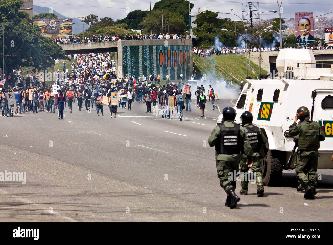 Members of the Bolivarian National Guard confront demonstrators on a highway in Caracas that were protesting against president Nicolas Maduro. Stock Photo