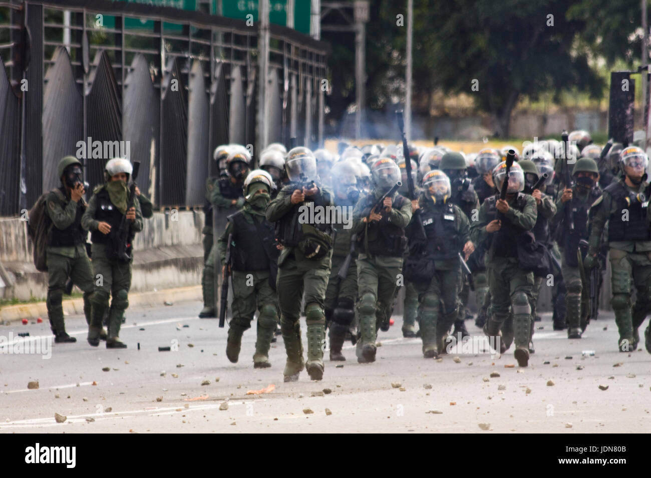 Members of the Bolivarian National Guard open fire against demonstrators during a protest against the government of Nicolas Maduro in Caracas. Stock Photo