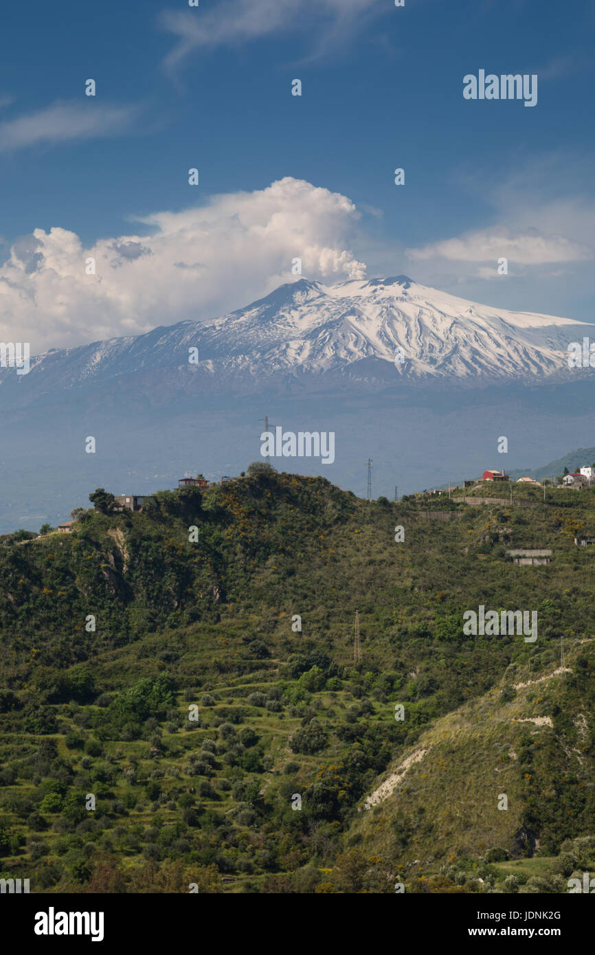 Snow capped peak of Mount Etna volcano in Adrano, Province of Catania with  smoke, gases or steam billowing from crater viewed from Taormina, Siciliy  Stock Photo - Alamy, image size:866x1390