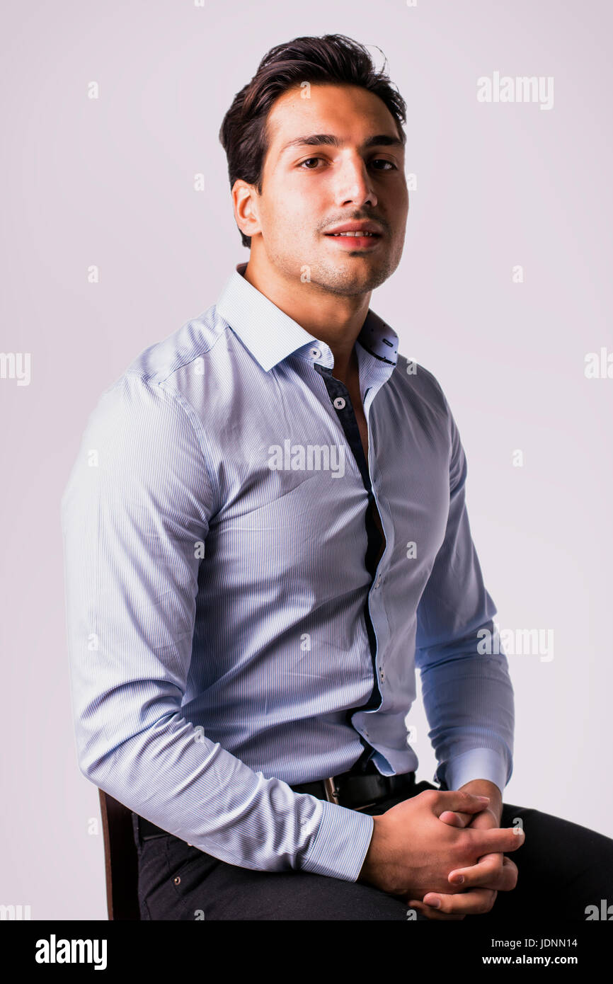 A Brown Eyed Black Haired Latin Man On Light Background Wearing