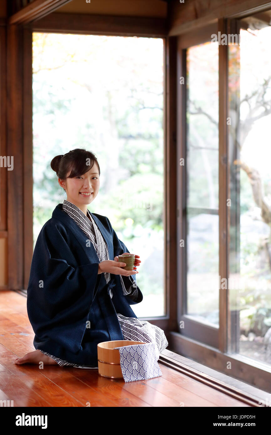 Japanese woman wearing a yukata at traditional ryokan, Tokyo, Japan