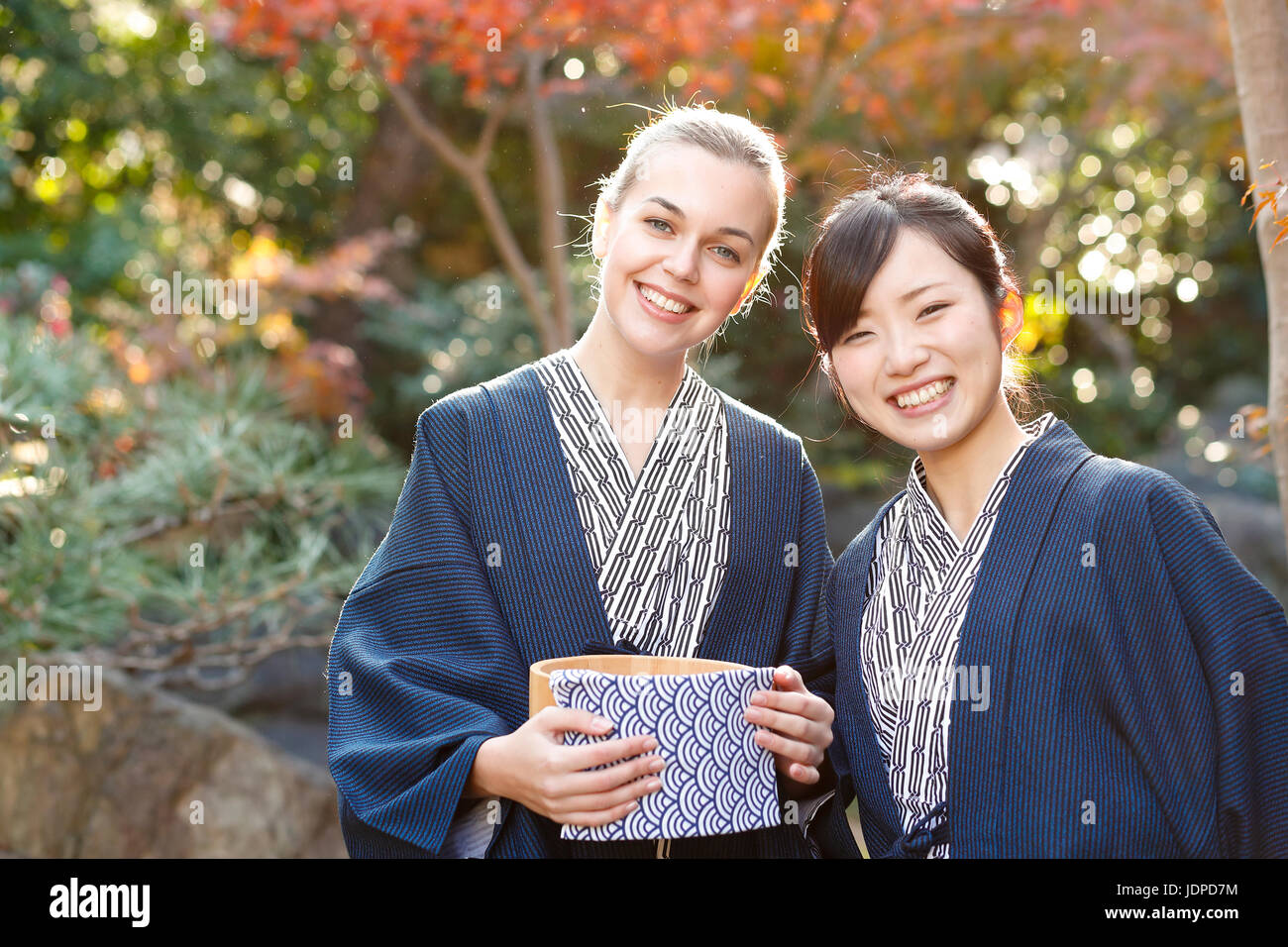 Caucasian woman wearing yukata with Japanese friend at traditional ryokan, Tokyo, Japan Stock Photo