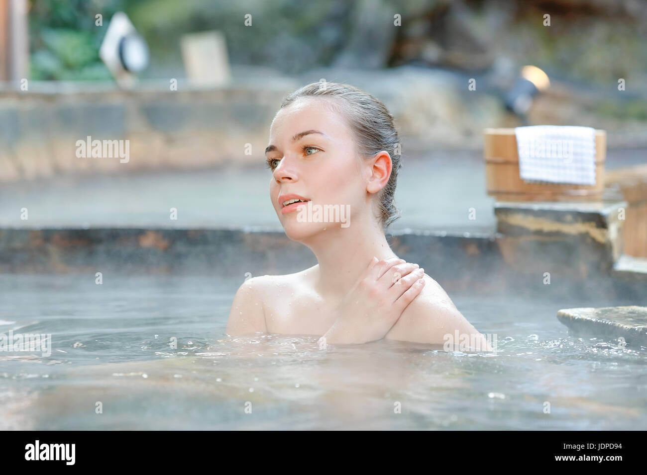 Caucasian woman bathing at traditional hot spring, Tokyo, Japan Stock Photo
