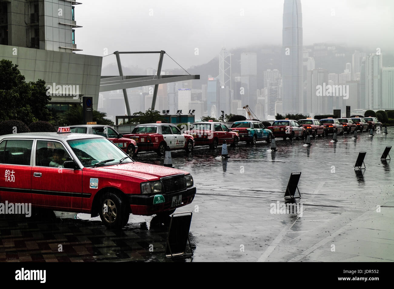 Rainy day in Hong Kong and red taxis queue line Stock Photo