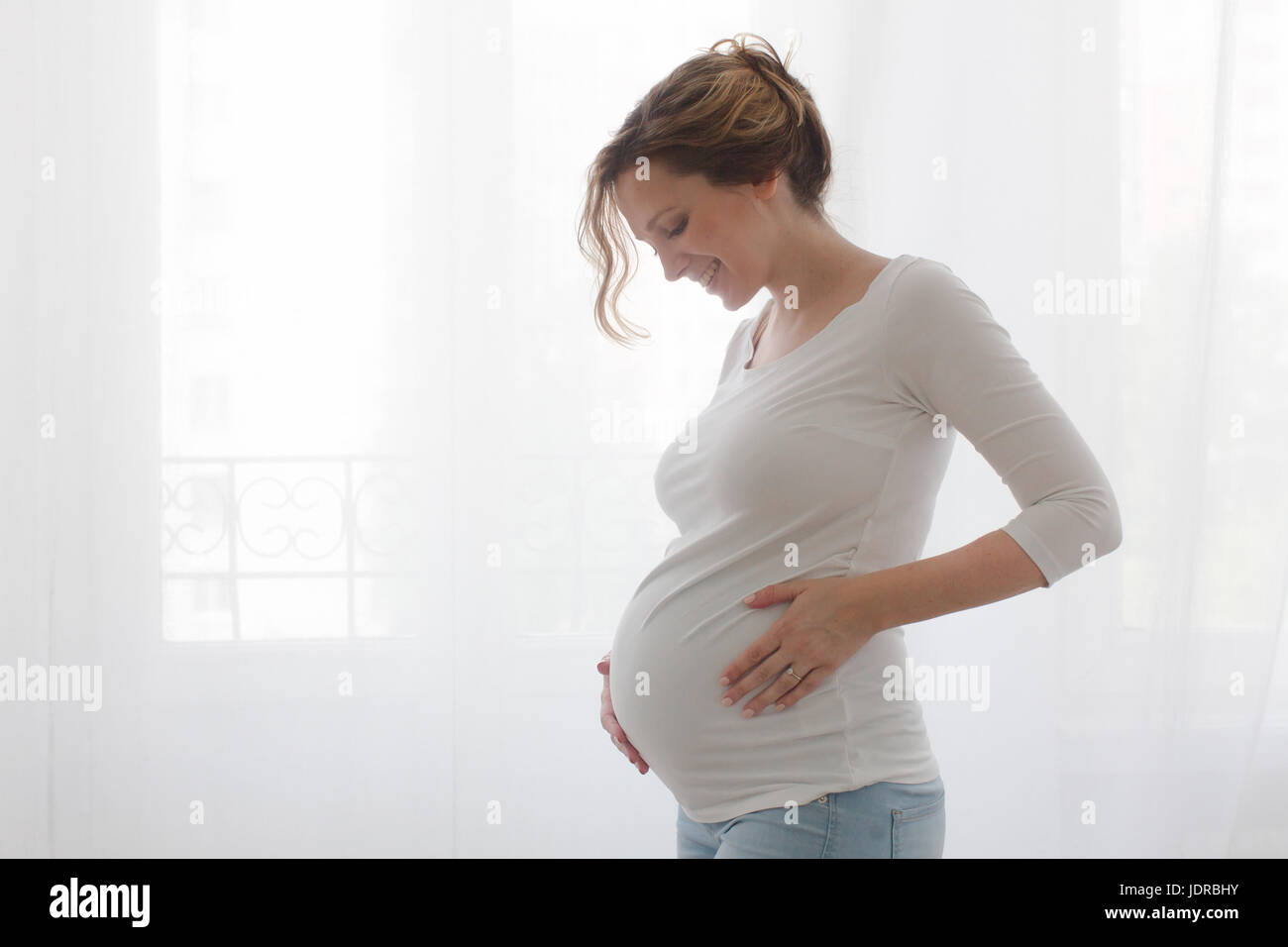 Pregnant woman touching belly Stock Photo Alamy