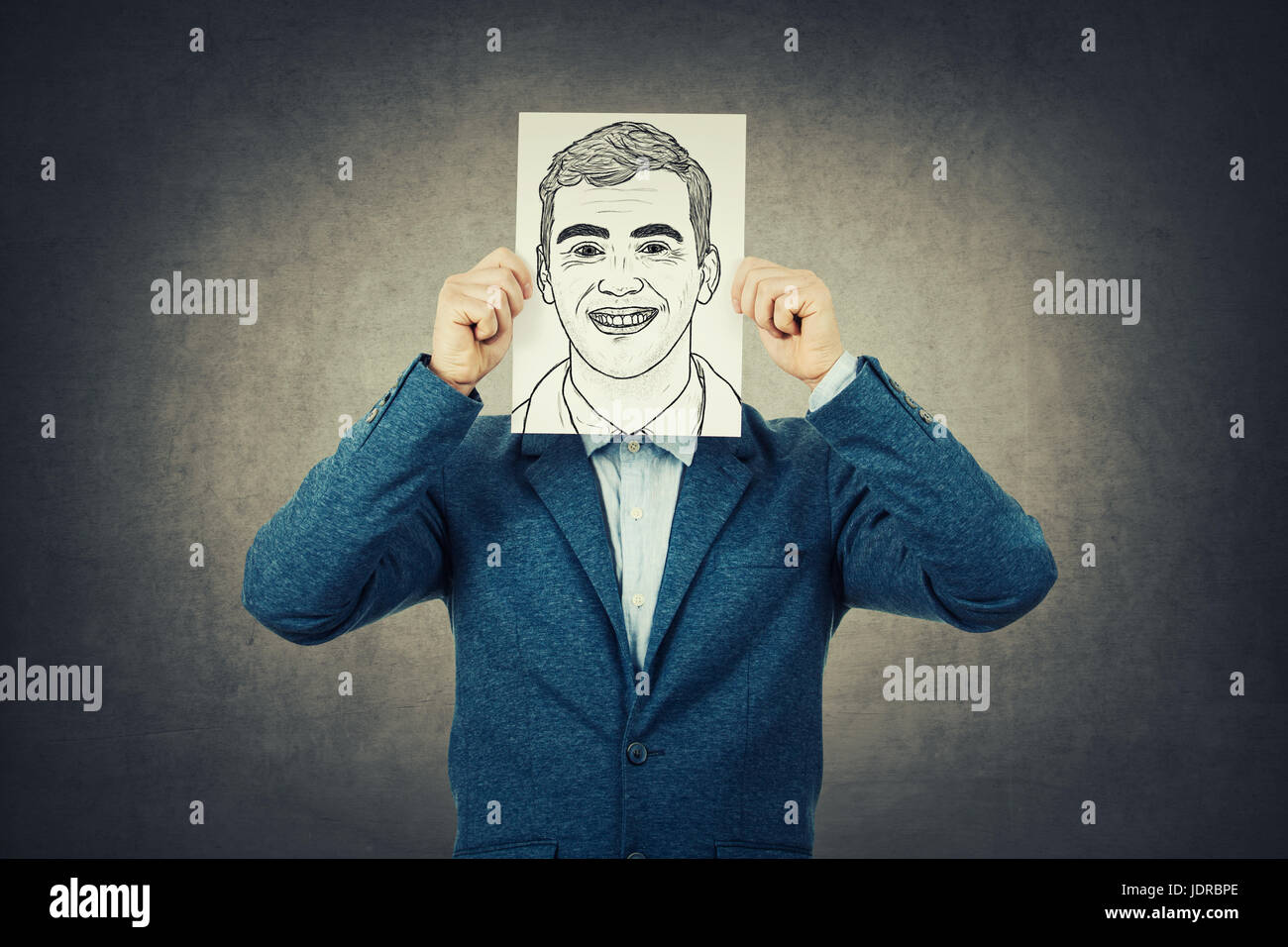 Businessman covering his face using a paper with self portrait sketch, like a mask for hiding the true emotion. Private life, faceless personality and Stock Photo