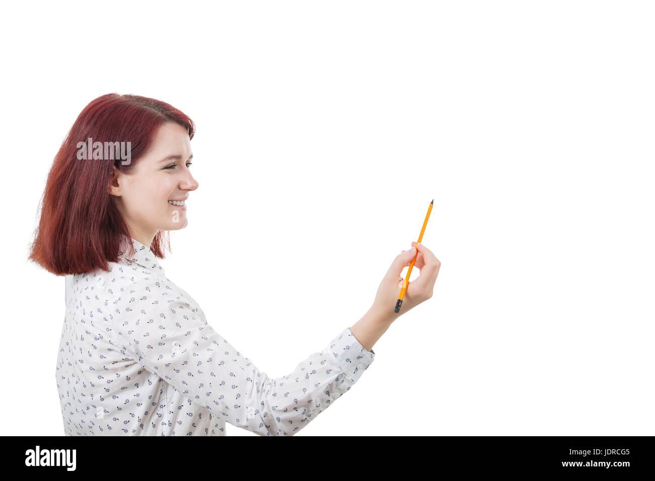 Smiling young student woman holding a pencil trying to develop her potential.Creativity concept. Stock Photo