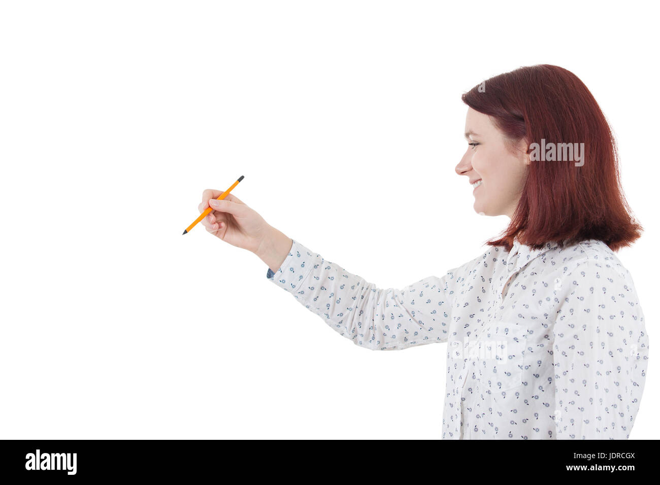 Smiling young student woman holding a pencil trying to develop her  potential.Creativity concept. Stock Photo