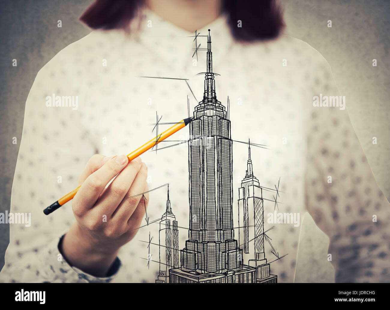 Young woman architect closeup sketching a construction project, the exterior of a skyscraper. Architectural drawing concept. Tall building business ce Stock Photo