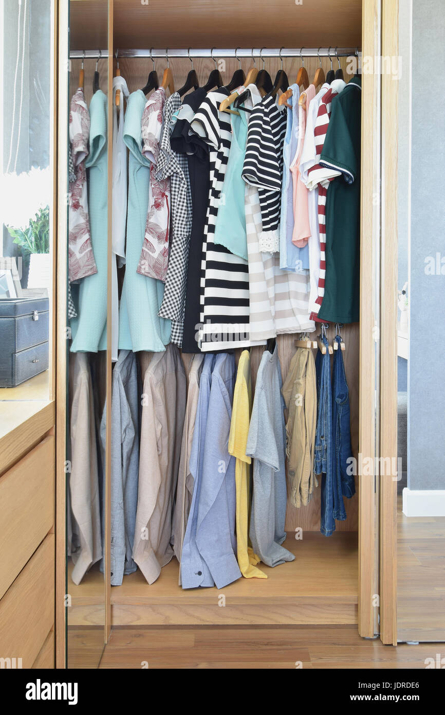 Colorful clothes hanging in wardrobe Stock Photo Alamy