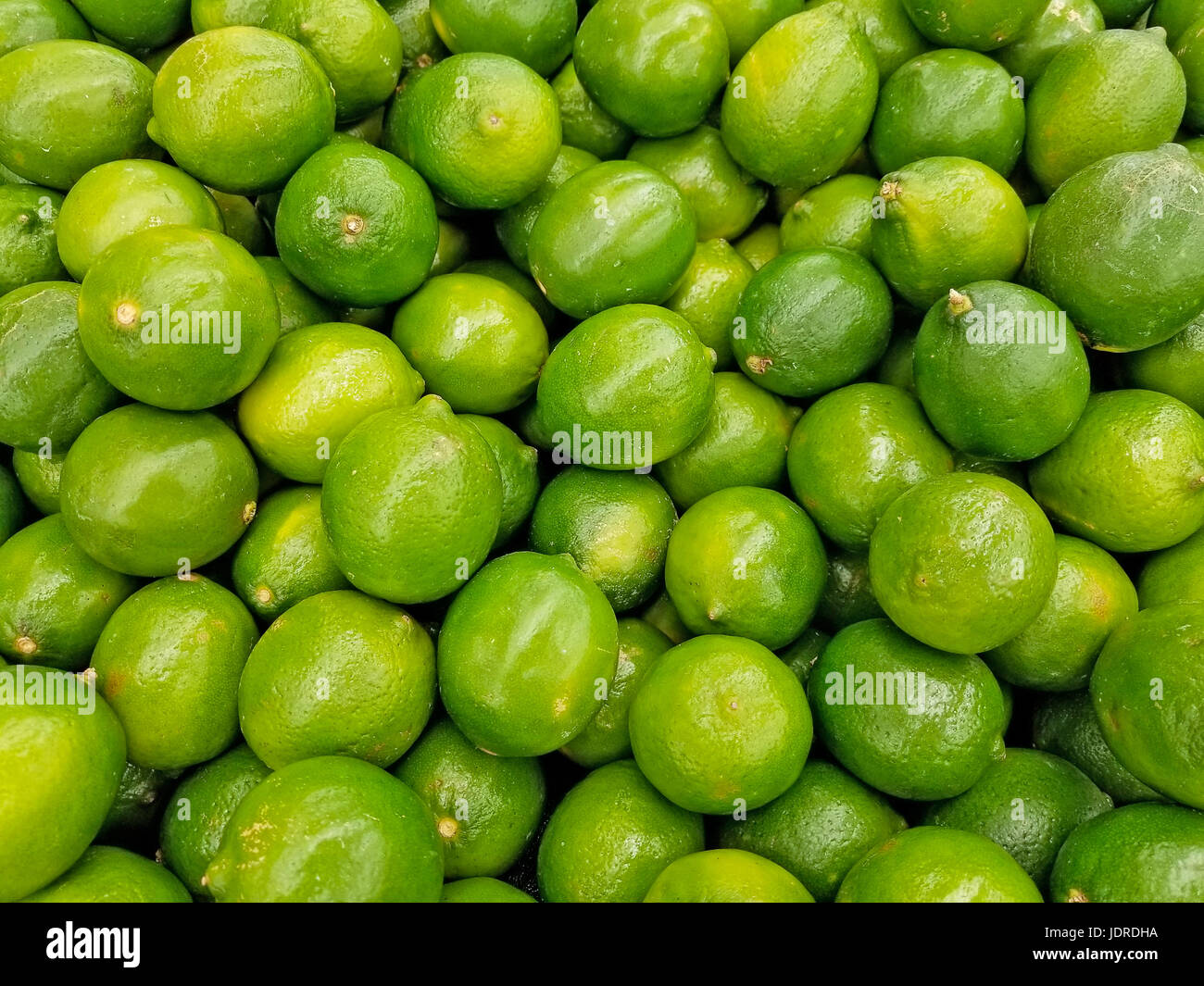 whole limes display in produce aisle Stock Photo
