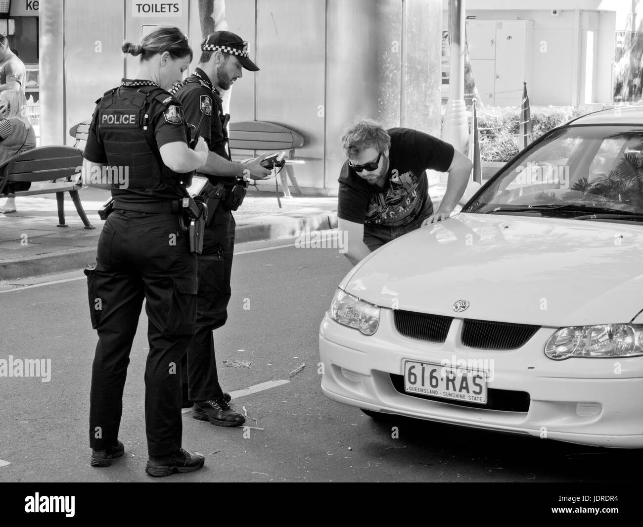 Policeman and policewoman checking vehicle after a hit and run accident Stock Photo