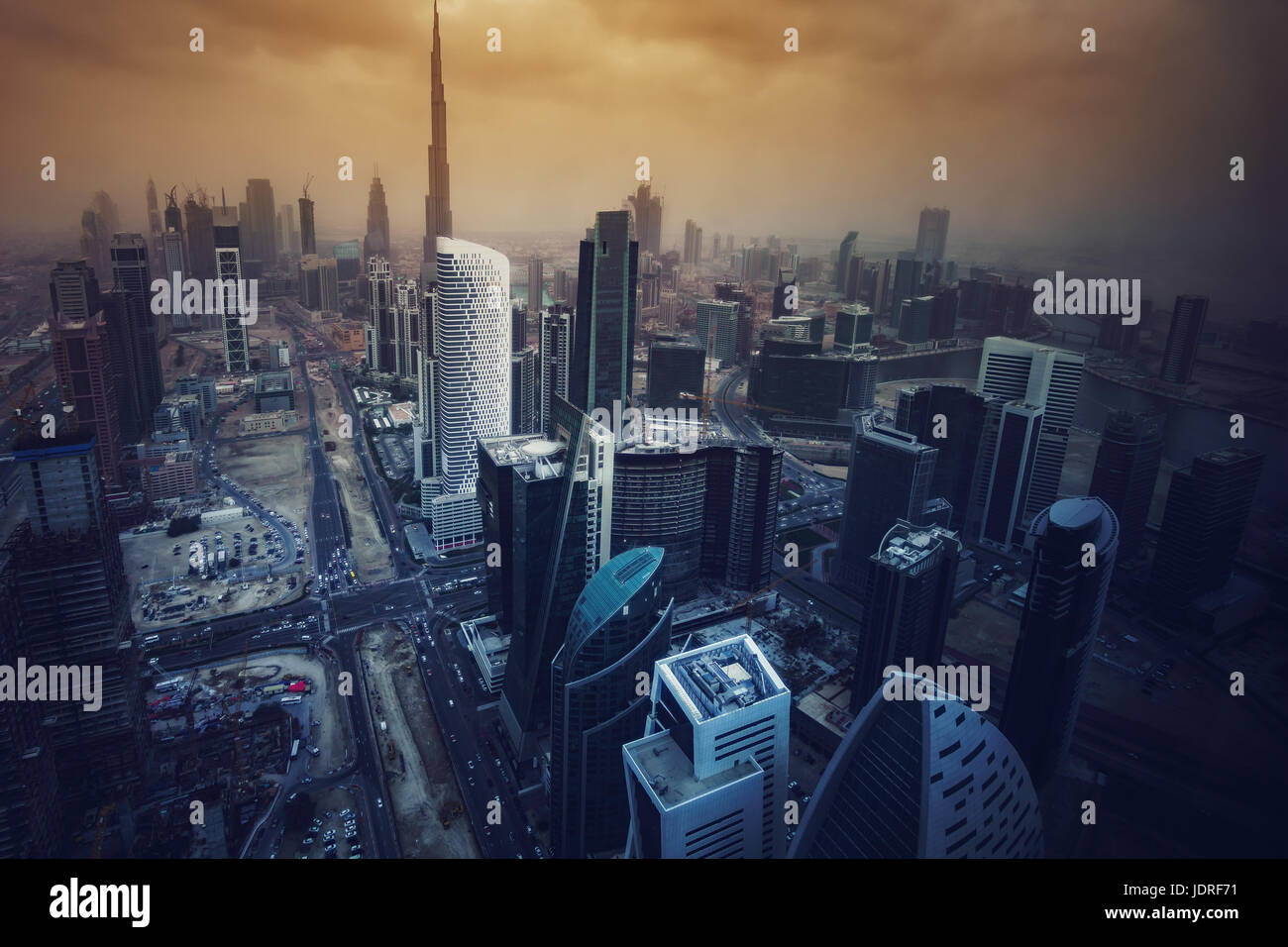 Architecture of a big modern city in dramatic light. Aerial view over the skyscrapers of downtown Dubai, United Arab Emirates. Stylized skyline. Stock Photo