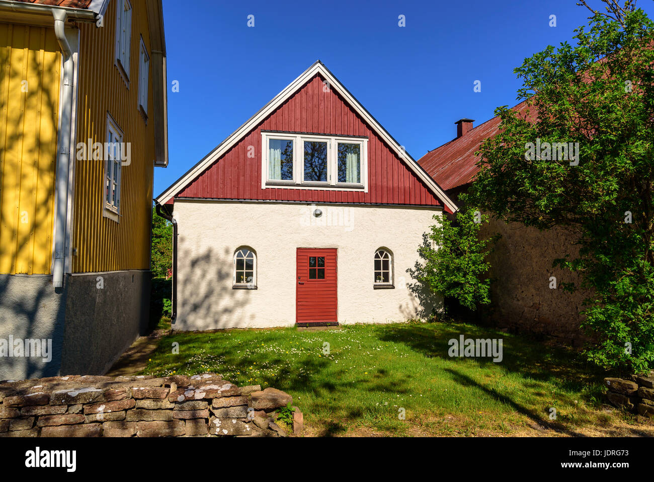 House built in a very tight squeeze between two other houses on a narrow property. Stock Photo