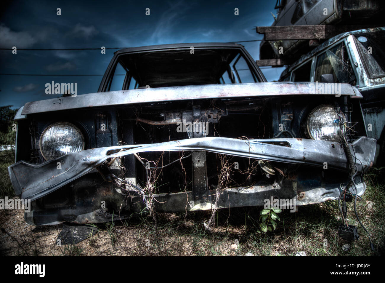 Front view HDR photo of Wrecked Automobile in Junkyard in Malaysia Stock Photo