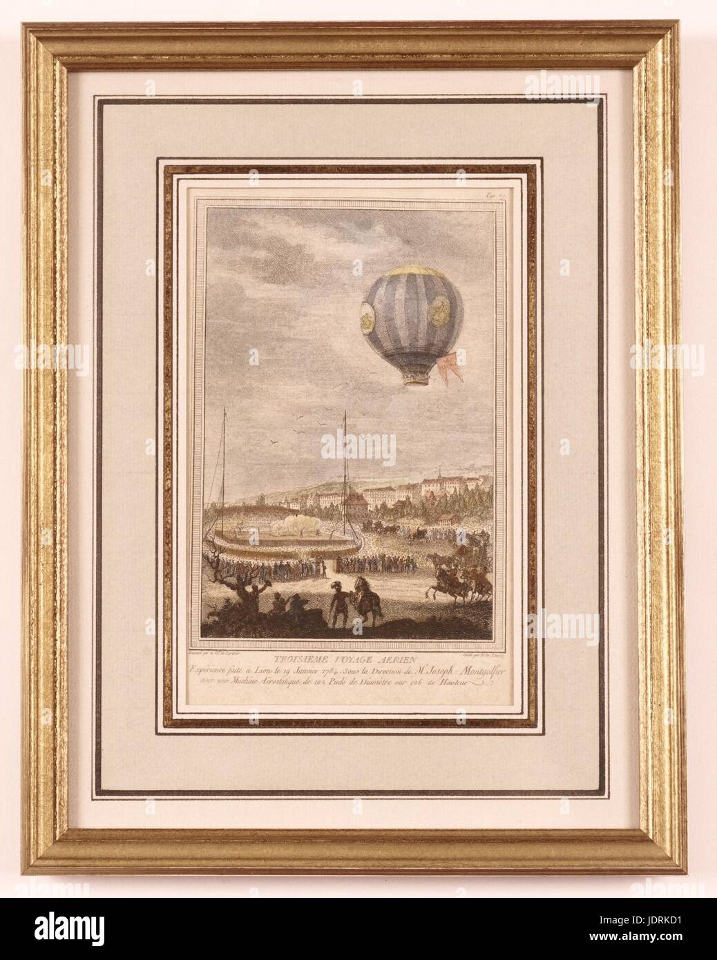 Le Chevalier de Lorimier, draftsman and Nicolas de Launay, etcher  Third human balloon flight on board the Flesselle in Lyon on 19th January 1784  Coloured etching with frame (28.5 x 22 cm)  Muller-Quênot Collection On 19th January 1784, le Flesselles rose up into the Lyon sky. As expected, seven passengers took their places in the gallery: the inventor of the hot-air balloon Joseph Montgolfier, who would be undertaking his final aerial voyage, Pilâtre de Rozier, Prince Charles de Ligne, the marquis de Laurencin and Dampierre, and the count de Laporte d’Anglefort. At the last moment they were  Stock Photo