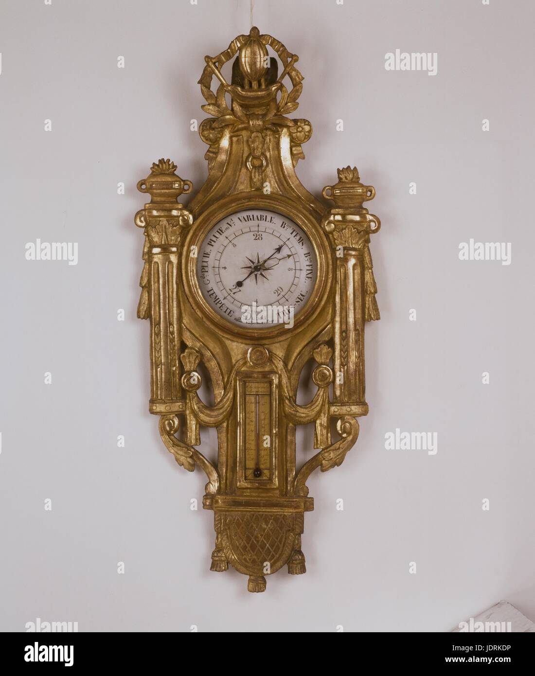 Barometer with hydrogen balloon design.  Sculpted gold wood (95 x 42 cm)  Muller-Quênot Collection On the pediment is a design of the hydrogen balloon invented by Charles and the Montgolfier brothers. Stock Photo